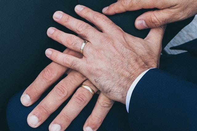 The left hands of two men on top of one another showing wedding bands on both hands
Eternity Wedding Rings